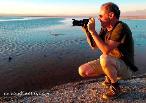 About - Dieter sitting photographing a sunset by the sea